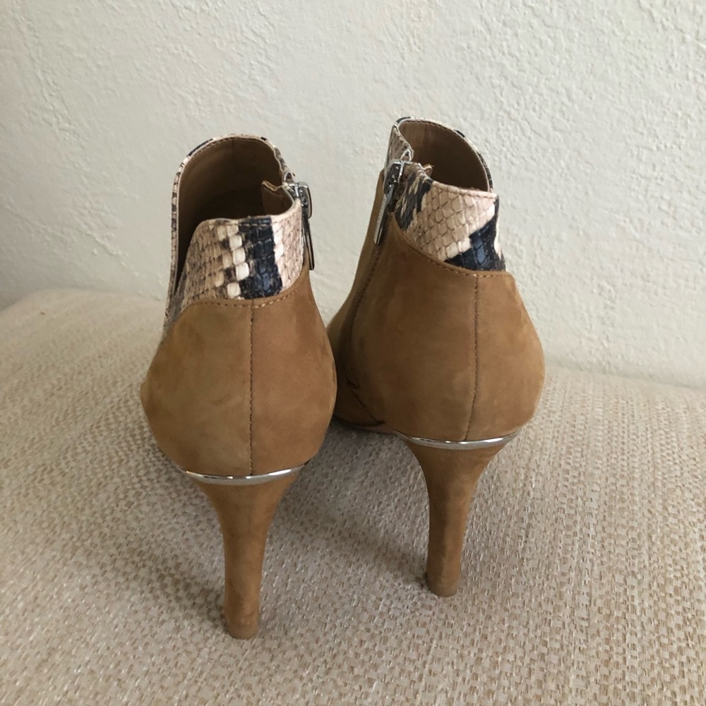 Beautiful camel color booties with snake print and silver details. Size 7